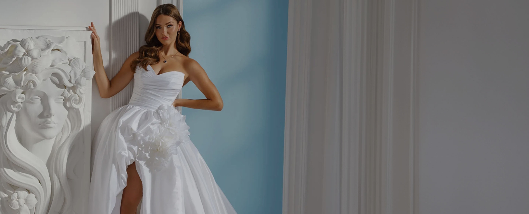 Photo of the posing model wearing a white bridal gown