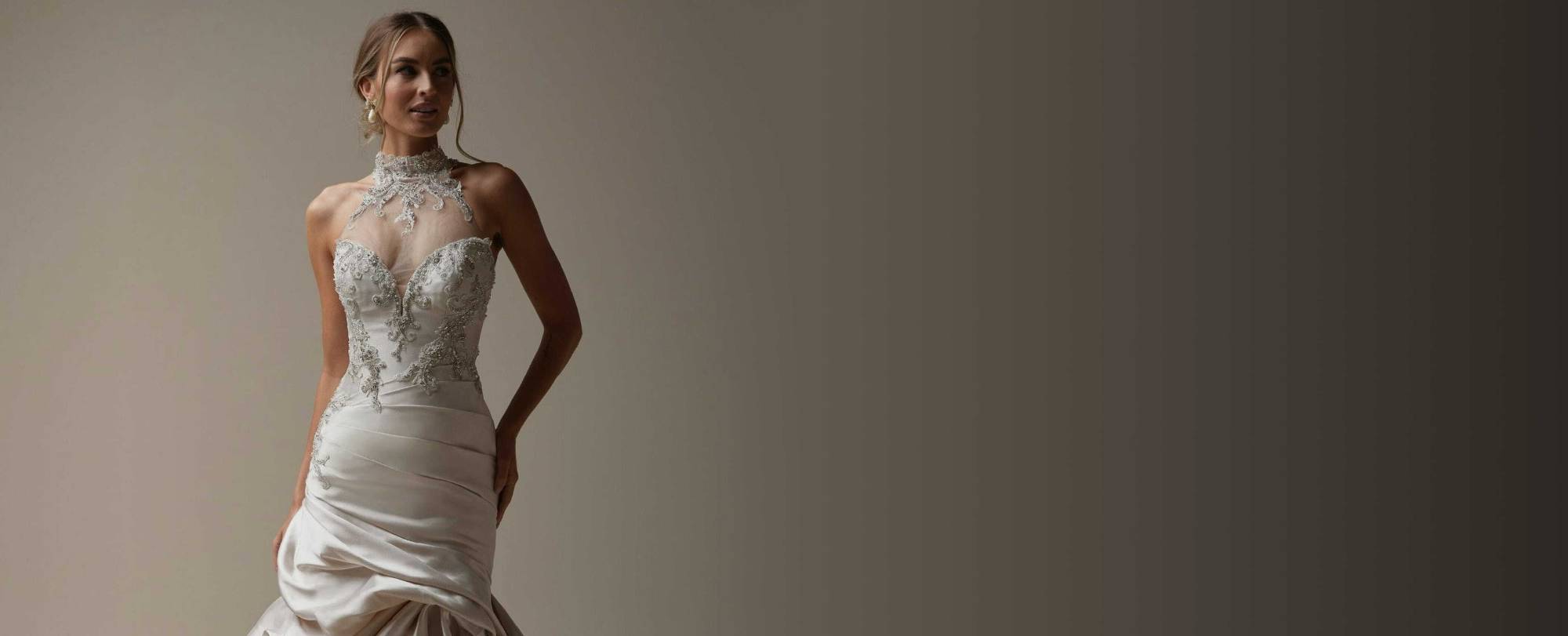 Photo of the posing model wearing a white bridal gown